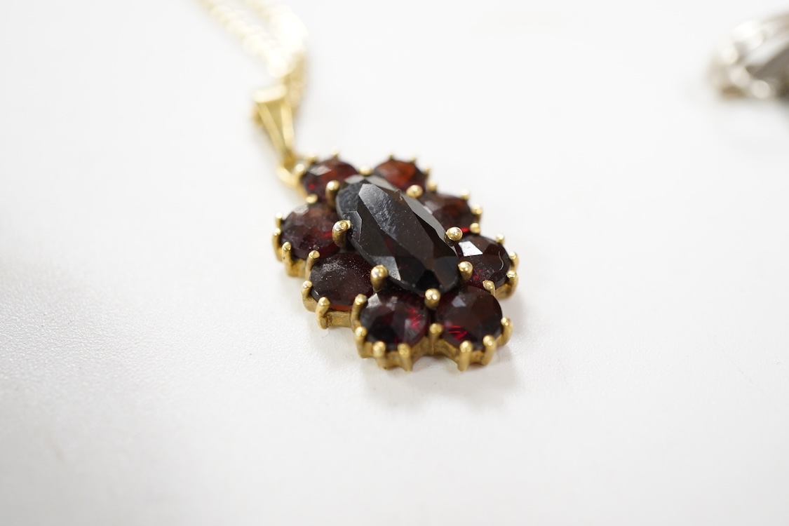 An 800 standard gilt white metal and garnet cluster set oval pendant, 18mm, on a 585 yellow metal fine link chain, 2.5 grams, a gilt white metal and garnet cluster set hinged bangle, two white metal brooches including on